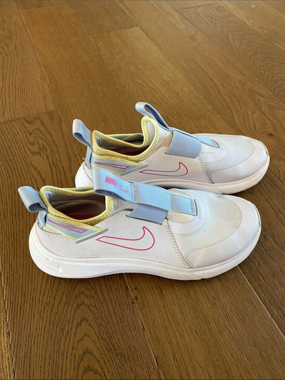 Nike Kids White Slip-On Sneakers with Pink Swoosh and Pastel Accents